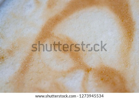 Drawing of a woman's face on a foam coffee latte in a glass created by a 3D printer close-up. 3d printer created a portrait of a girl on the foam of brewed coffee