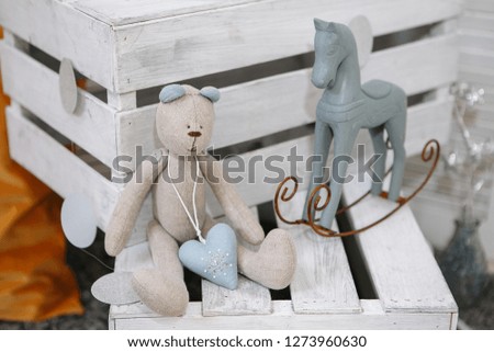 Kids toys. Bear and horse are sitting on a decorative box.