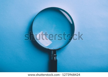 Magnifying is isolated on the blue background.