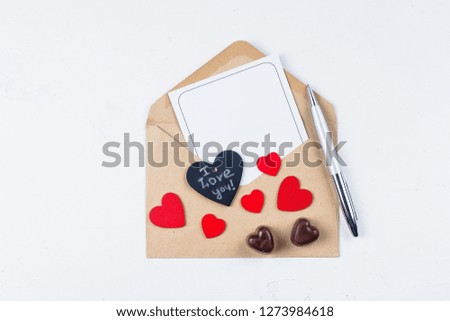 Valentines day mockup. Love card. Paper card with envelope and chocolate candy on white table background. Flat lay, top view, place for space