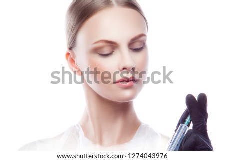 Doctor woman with syringe wearing medical uniform. White background. Isolated. Human health concept