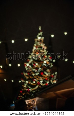 Christmas abstract blur background. Christmas tree with defocused lights. Bokeh - heart.