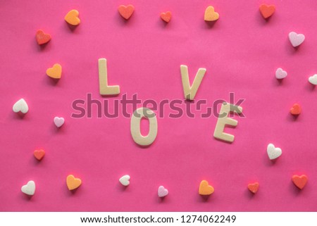 many hearts with word LOVE on pink background, Love icon, valentine's day, relationships concept with copy space