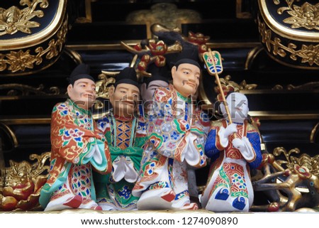 Beautiful ancient wood carved image of a group of noblemen at Toshogu Shrine at Nikko, Japan