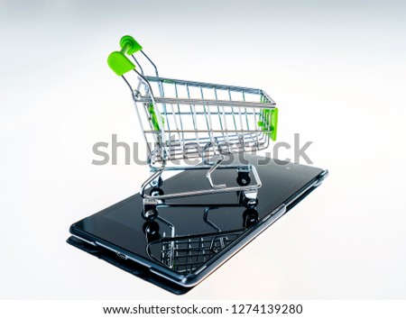 green shopping cart and tablet
