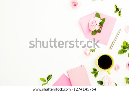 Valentines day composition with roses flowers, pink envelope and coffee mug on white background. Flat lay, top view.
