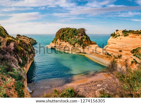Colorful summer view of famous Channel Of Love (Canal d'Amour) beach. Sunny morning seascape of Ionian Sea. Amazing outdoor scene of Corfu Island, Greece, Europe. 