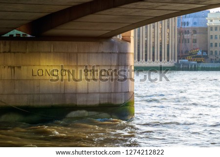 Underside of London Bridge with engraved name in the UK