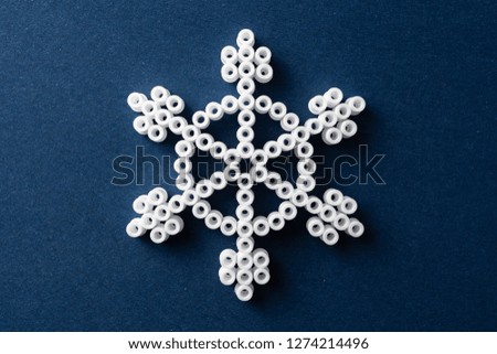 Design concept - simplicity white snowflake on blue background