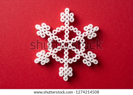 Design concept - simplicity white snowflake on red background