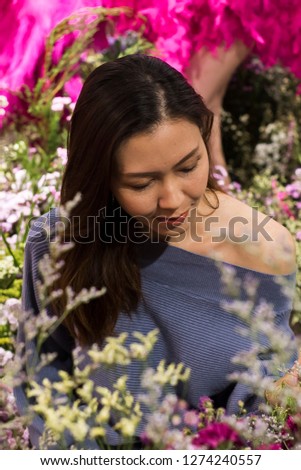 Beautiful women admire flowers