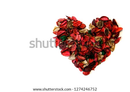Red heart made of flower petals, on a white background, with copy space. The concept of a sign of love or Valentine's day.