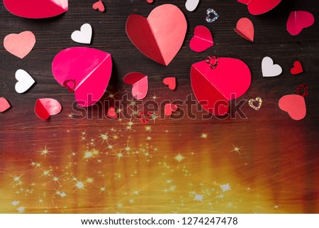 Flying red paper hearts on wooden background. Valentine's Day. Symbol of love.