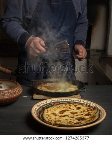 man in an apron fries pancakes