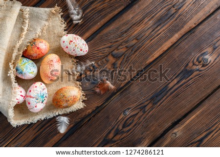Easter eggs wrapped in canvas fabric on dark wooden background Royalty-Free Stock Photo #1274286121