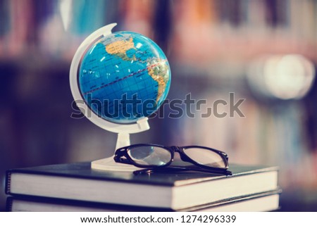 Back to school background with world globe and book