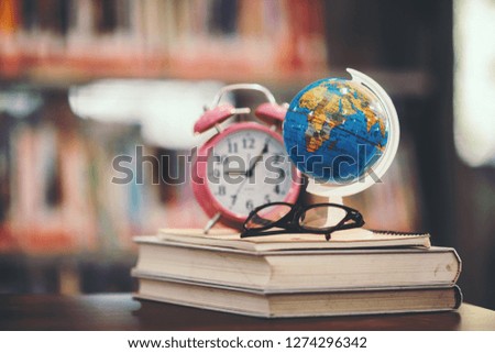 Back to school background with world globe and book