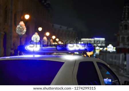 Police car with a special signal on the street of the night city