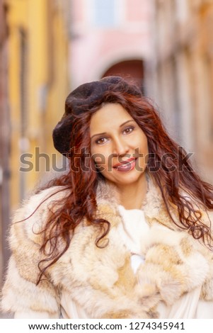 happy tourist walking in historical center of Italian town. The girl has Middle Eastern somatic features