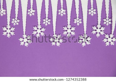 White snowflakes on a purple background. Decorations forming a Christmas background