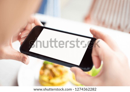 woman's holding smart phone and use take photo. soft focus.