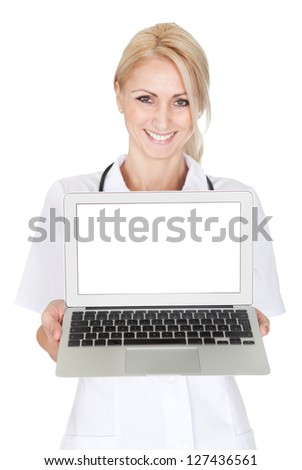 Smiling medical doctor woman presenting laptop. Isoalted on white