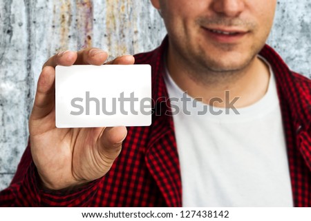 Construction worker holding a blank business card, business introduction concept.