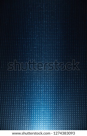 A ray of light on a dark blue checkered background