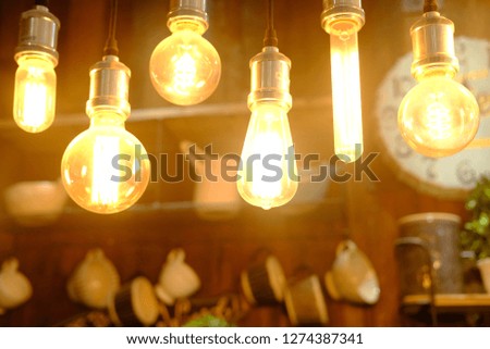 Vintage bulb lamps in the interior of a stylish bar and modern cafe  blured background photo
