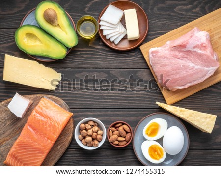 Selection of Ketogenic diet products on wooden background with copyspace in the center. Ketogenic diet eating concept. Royalty-Free Stock Photo #1274455315