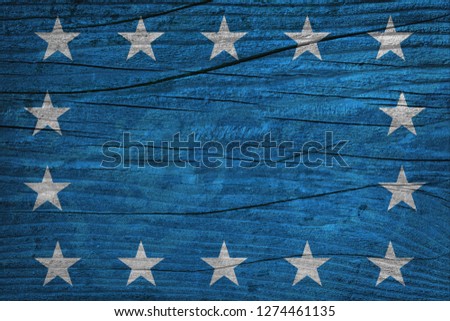 White stars superimposed on blue wooden background. 