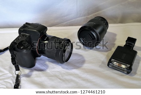 Photographer camera, camera lens and gadgets over white background