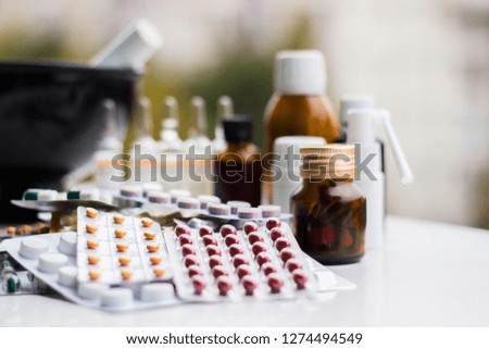 Mortar and pestle with pills and pill bottles