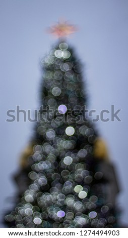 Abstract christmas background with christmas tree defocused bokeh lights outdoors.