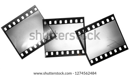 Set of three 35mm film frames or strips on white, overlapping photo placeholder, film material with reflection