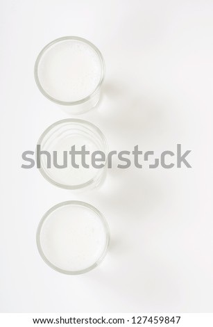 Three little glasses with milk