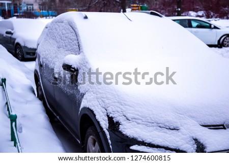 in the winter the car is covered with snow