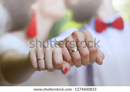 wedding rings, hands of the bride and groom close up