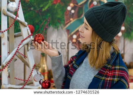 

blonde young girl near christmas tree and decoration