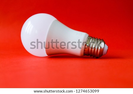 LED lamp bulb on red background                            