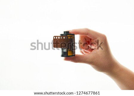 roll of film in hand on white background