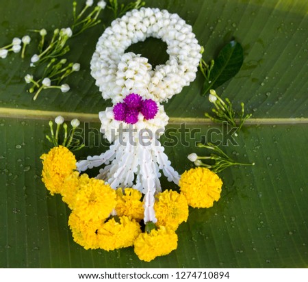 Thai traditional flower garland on banana leaf. Hand make by Thai people.
