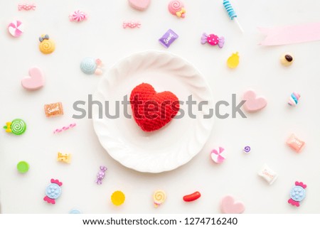 Valentine's day background with red heart shape on white plate and valentine's day composition, View from above.