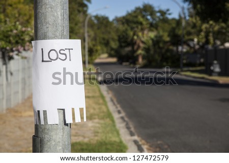 lost sign on a lampost in a suburban street