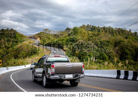 Cars running on the beautiful road along the mountain, Rear view of pickup truck on wavy road Royalty-Free Stock Photo #1274734231