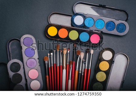 set of professional makeup brushes and palette with color eye shadow close-up