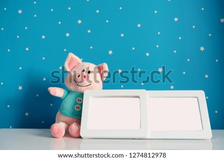 picture frame and piggy toy in baby room