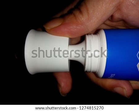 Right  hands Unopened tube of toothpaste.Try to open it. Royalty-Free Stock Photo #1274815270