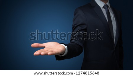 Businessman without head holding something without theme Royalty-Free Stock Photo #1274815648