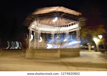 Tribute to Monet, tribute to Ernst Hass, impressionist photograph of the stand for music in the park, Toledo, Spain, photographic sweeps at low shutter speed, night photo, motion sensation,  
